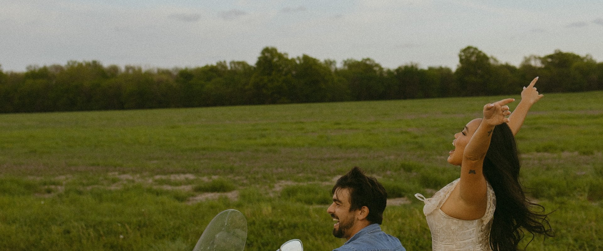 Hana and Jaydon on a motorcycle on an open road