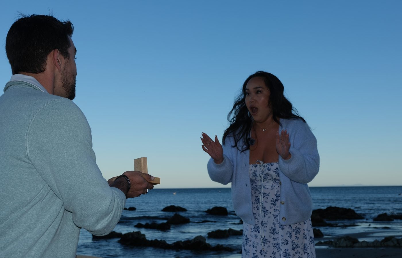 Hana reacting to the surprise proposal on the beach